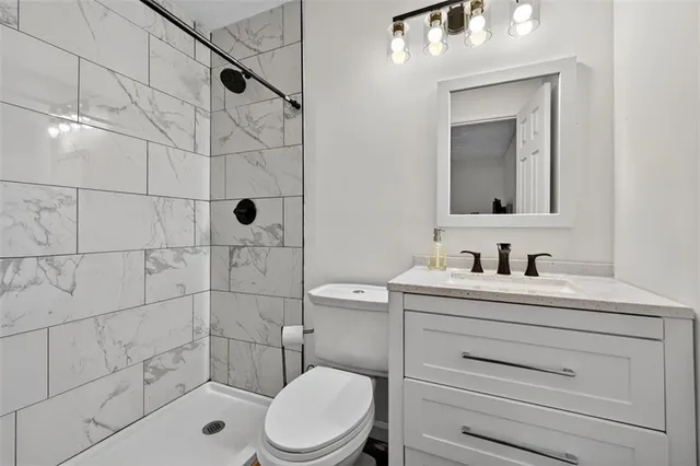 a bathroom with a sink a toilet and shower