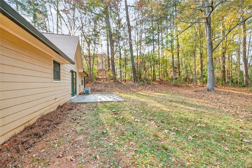 494 Spring Street Social Circle, GA 30025 - Photo 21 of 21 a view of a backyard with large trees