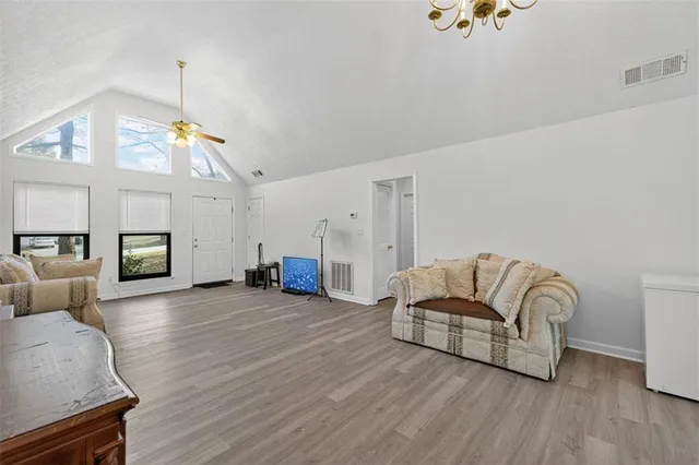 a living room with furniture and a wooden floor