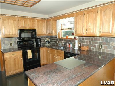 3600 Gun Club Road Nazareth, PA 18064 - Photo 7 of 27 a kitchen with a stove a sink and a microwave