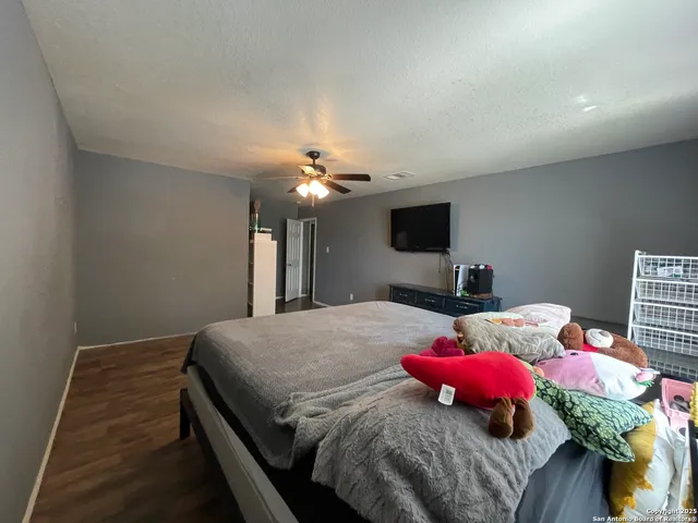 a bedroom with a bed and flat screen tv
