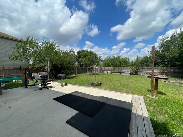 a view of a park with bench and trees