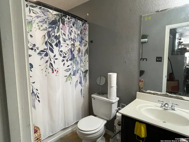 a bathroom with a sink toilet and shower