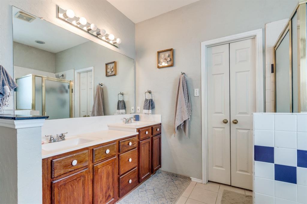 2031 Knights Court Allen, TX 75013 - Photo 6 of 12 a bathroom with a double vanity sink and mirror