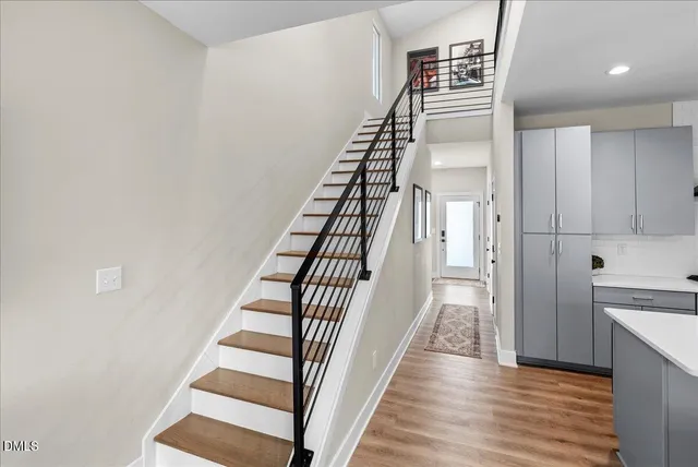 a bedroom with a large bed a flat tv screen and a window