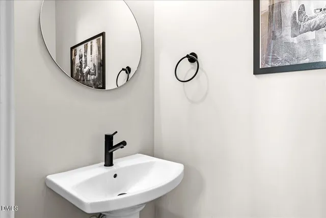 a kitchen with stainless steel appliances granite countertop a sink a stove and a wooden floors