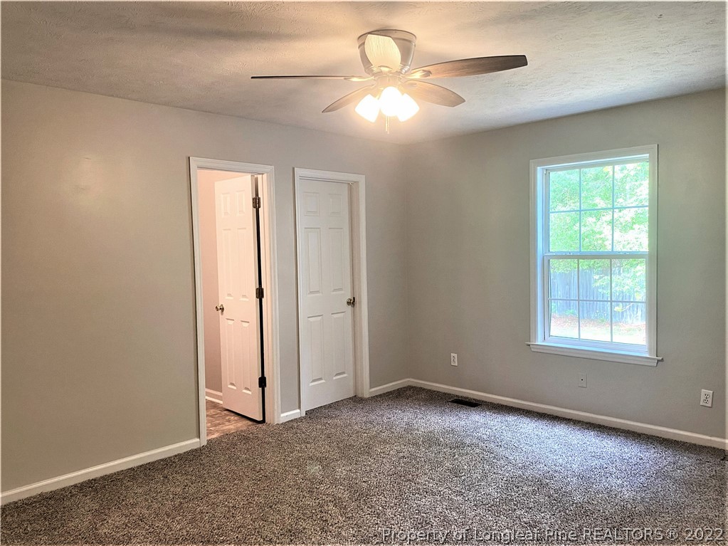 1298 Roundabout Road Cameron, NC 28326 - Photo 12 of 29 an empty room with windows and fan