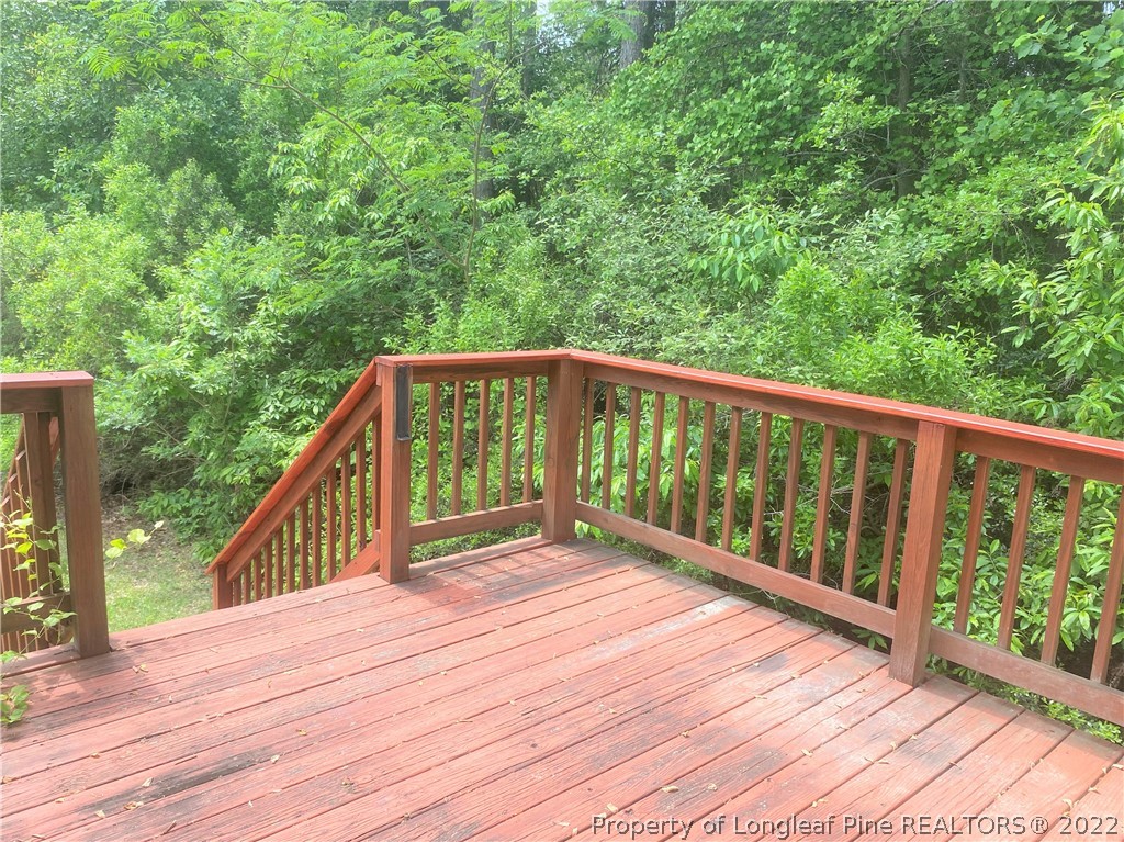 1298 Roundabout Road Cameron, NC 28326 - Photo 24 of 29 a view of balcony with wooden floor and fence