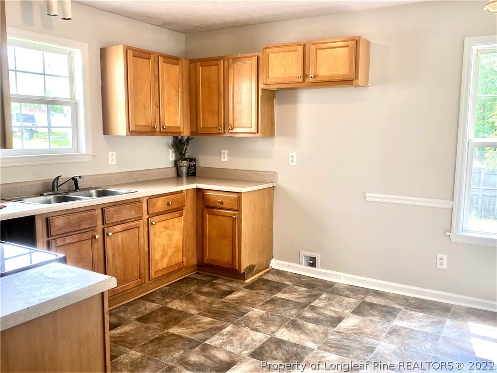 1298 Roundabout Road Cameron, NC 28326 - Photo 10 of 29 a kitchen with a sink cabinets and window