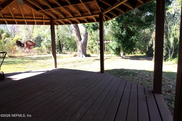 a view of a room with wooden floor and outdoor space
