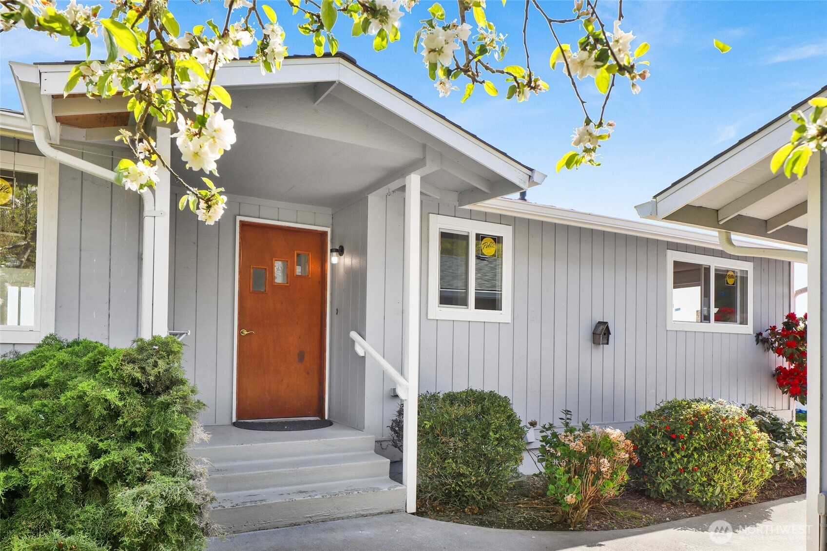 a front view of a house with flowers