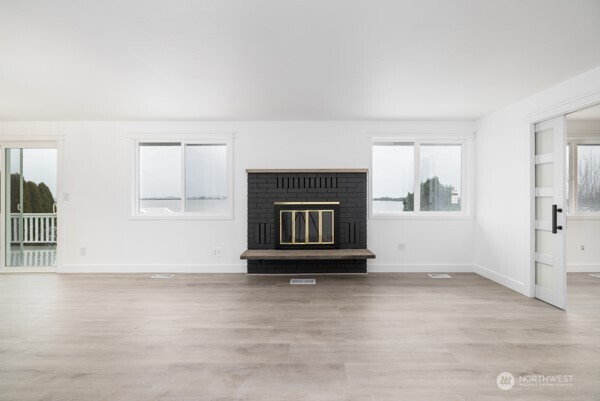 11586 Scott Road Bow, WA 98232 - Photo 11 of 28 an empty room with windows and fireplace