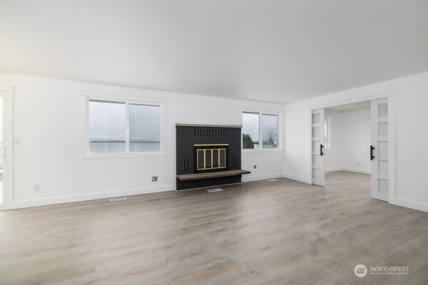 11586 Scott Road Bow, WA 98232 - Photo 12 of 28 a view of an empty room with a fireplace and a window