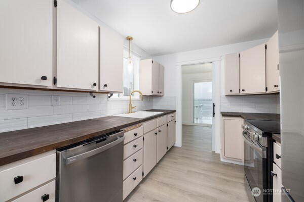 11586 Scott Road Bow, WA 98232 - Photo 17 of 28 a kitchen with granite countertop white cabinets and white appliances