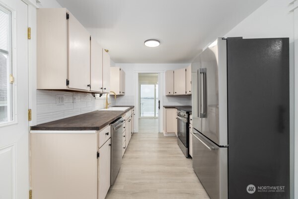 11586 Scott Road Bow, WA 98232 - Photo 18 of 28 a kitchen with stainless steel appliances granite countertop a refrigerator and a stove