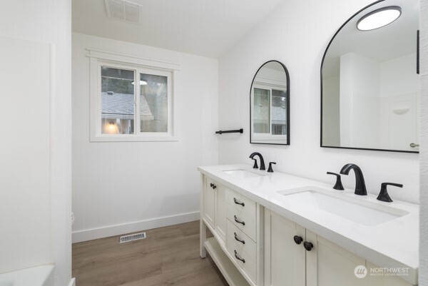 11586 Scott Road Bow, WA 98232 - Photo 19 of 28 a bathroom with a double vanity sink and mirror