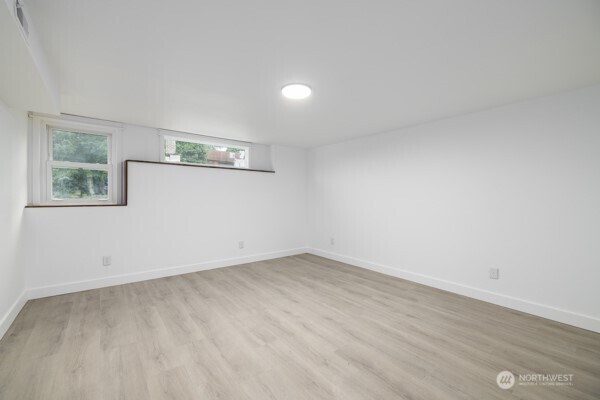 11586 Scott Road Bow, WA 98232 - Photo 25 of 28 an empty room with wooden floor and windows
