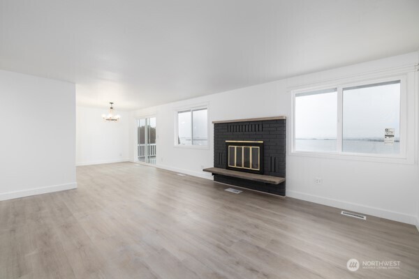 11586 Scott Road Bow, WA 98232 - Photo 28 of 28 an empty room with windows and fireplace