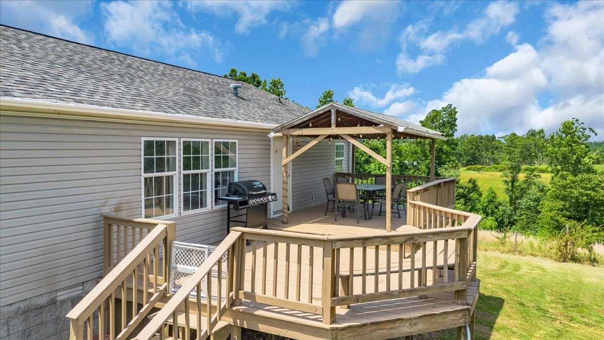 2657 Oak Grove Road Red Boiling Springs, TN 37150 - Photo 36 of 45 a view of house with a deck and furniture