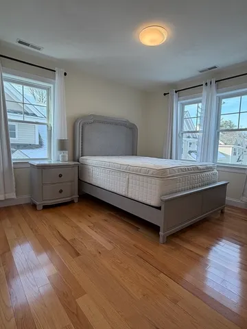a spacious bedroom with a bed and window