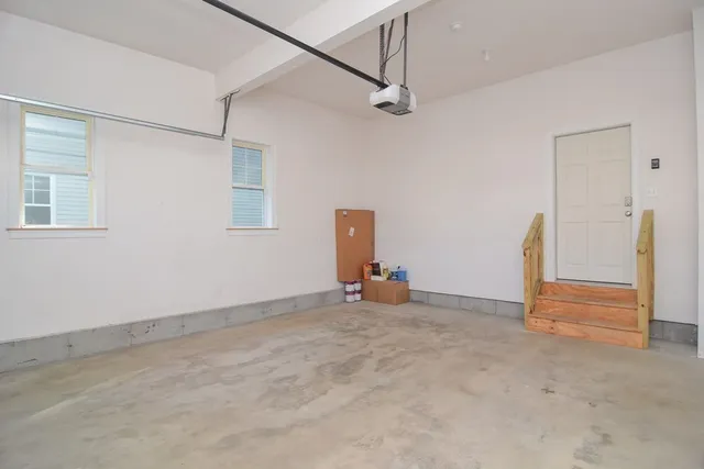 an empty room with closet and a chandelier fan