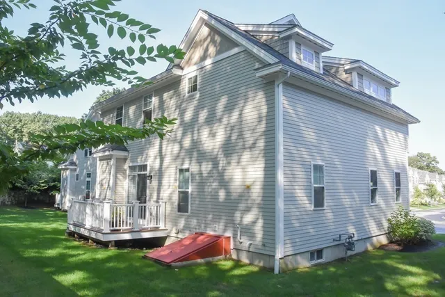 a view of a house with a yard and sitting area