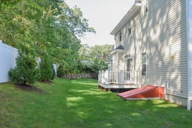 a view of backyard with swimming pool and green space