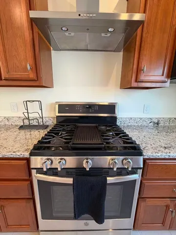 a stove top oven sitting inside of a kitchen