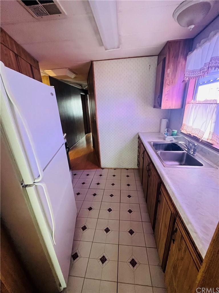 16601 Garfield Avenue, Unit 128 Paramount, CA 90723 - Photo 13 of 32 a bathroom with a sink a vanity and a mirror