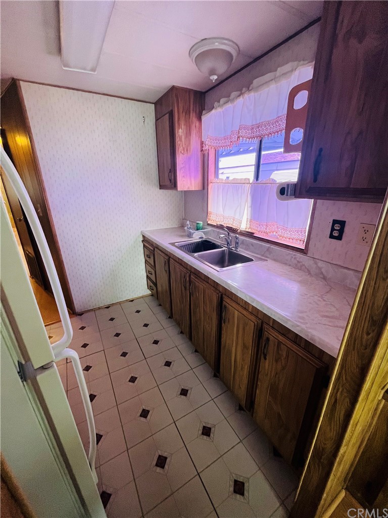 16601 Garfield Avenue, Unit 128 Paramount, CA 90723 - Photo 14 of 32 a kitchen with stainless steel appliances a stove a sink and a microwave