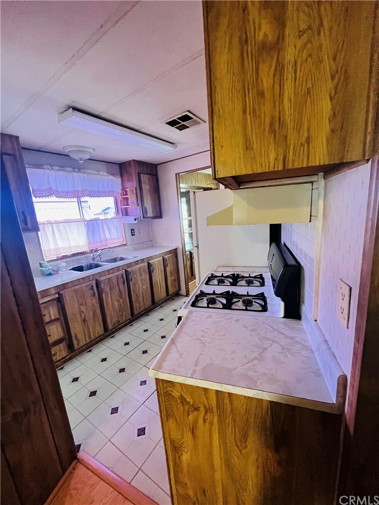 16601 Garfield Avenue, Unit 128 Paramount, CA 90723 - Photo 17 of 32 a bed sitting in a bedroom next to a window