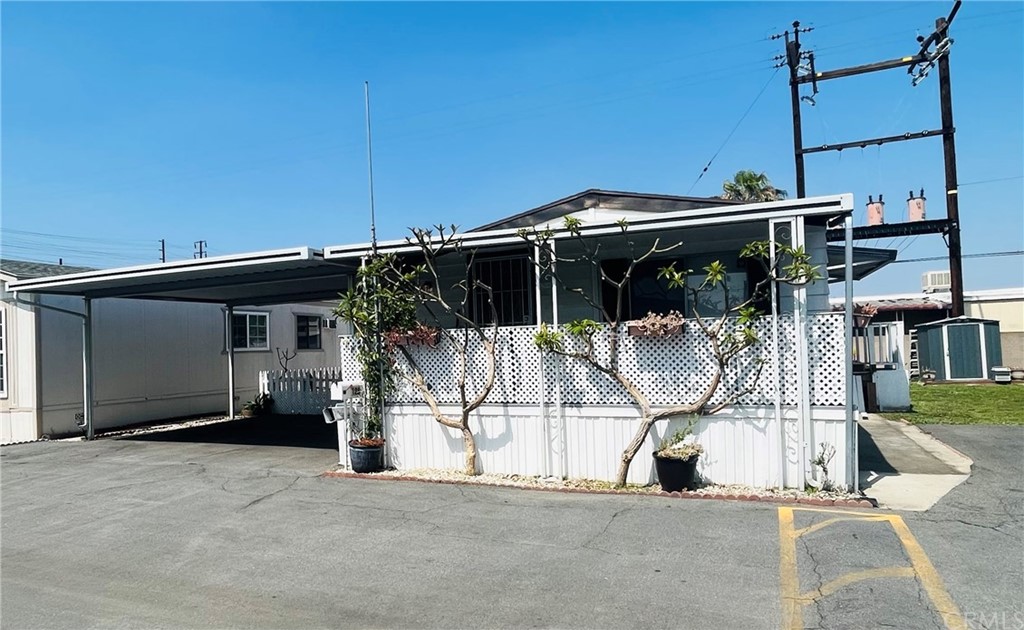 16601 Garfield Avenue, Unit 128 Paramount, CA 90723 - Photo 2 of 32 a house view with a outdoor space