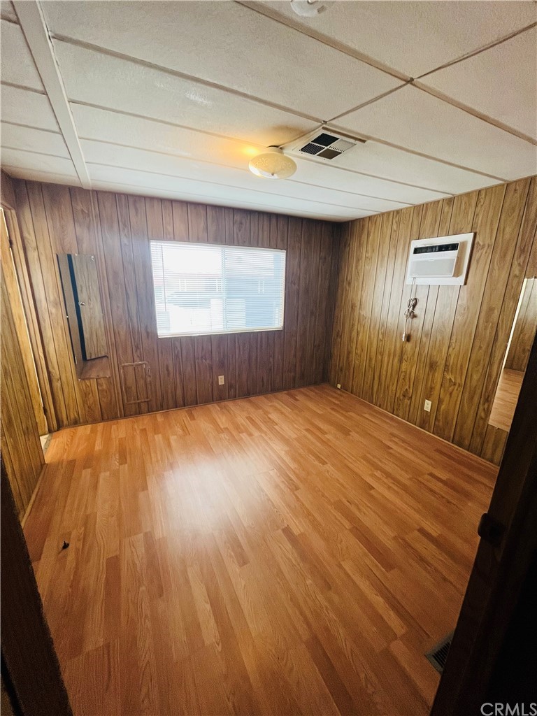 16601 Garfield Avenue, Unit 128 Paramount, CA 90723 - Photo 21 of 32 a view of empty room with wooden floor