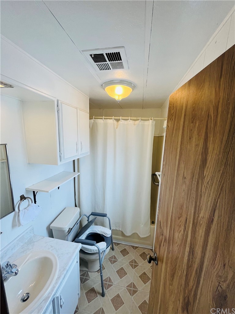 16601 Garfield Avenue, Unit 128 Paramount, CA 90723 - Photo 24 of 32 a bathroom with a sink toilet and shower