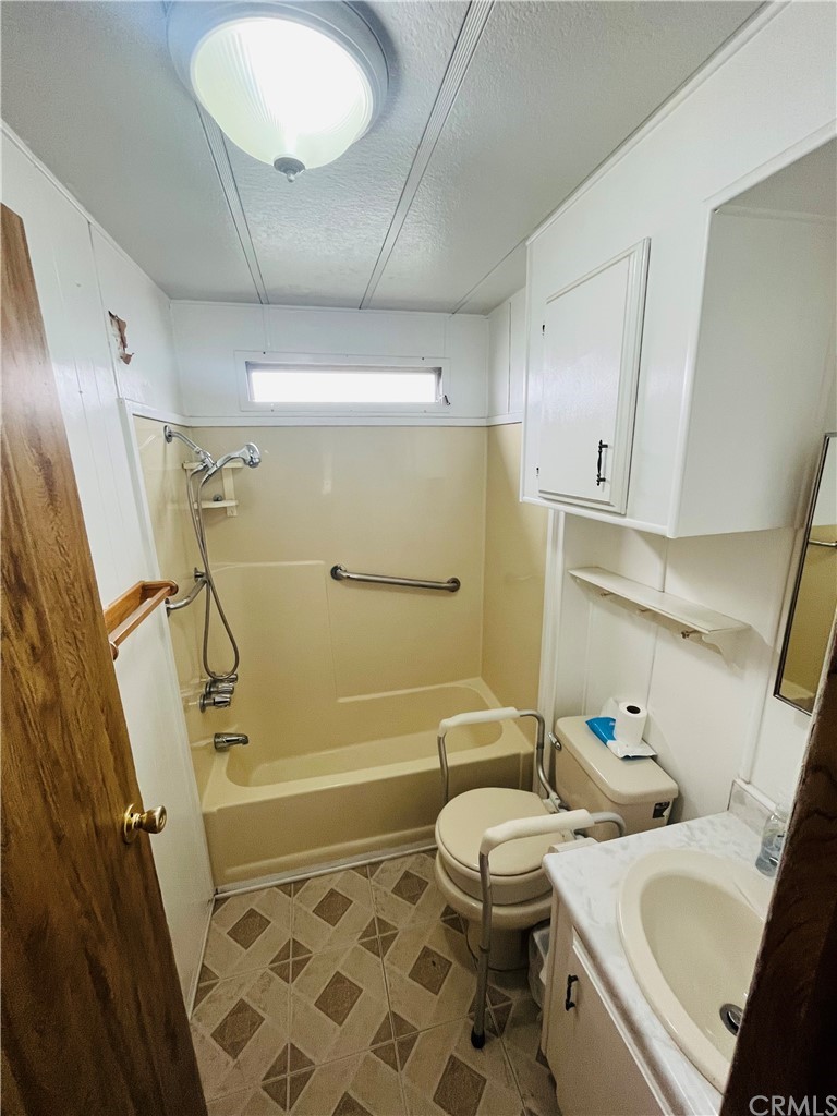 16601 Garfield Avenue, Unit 128 Paramount, CA 90723 - Photo 26 of 32 a bathroom with a sink a toilet and shower