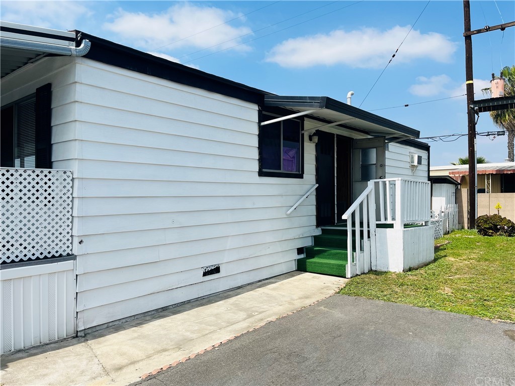 16601 Garfield Avenue, Unit 128 Paramount, CA 90723 - Photo 28 of 32 a view of a house with a garage