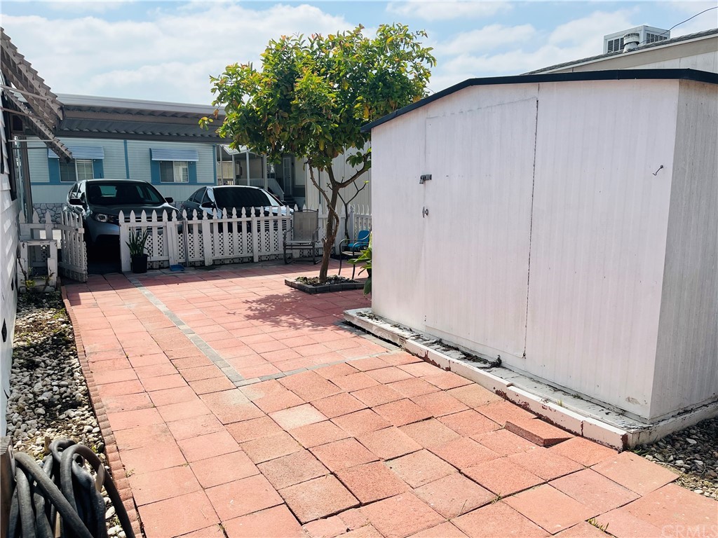 16601 Garfield Avenue, Unit 128 Paramount, CA 90723 - Photo 30 of 32 a view of a porch with wooden fence and bench