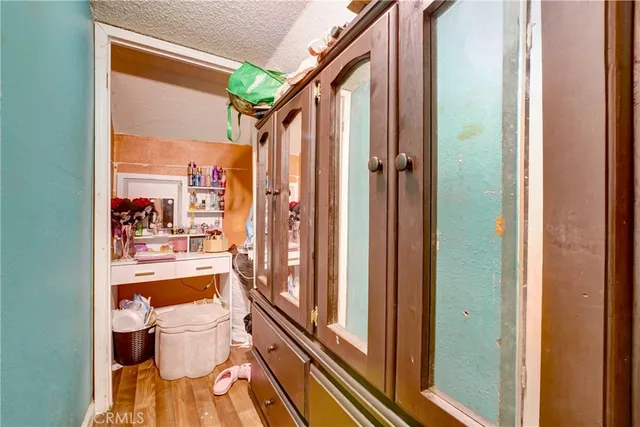 a bathroom with a granite countertop sink and a large mirror