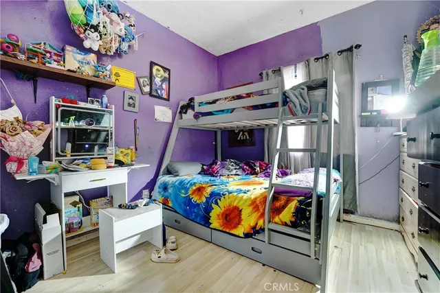 a bedroom with a bed and a tv on table