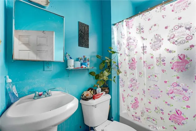 a bathroom with a sink mirror and toilet