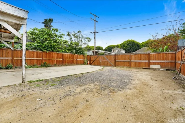 a front view of a house with a garden and parking