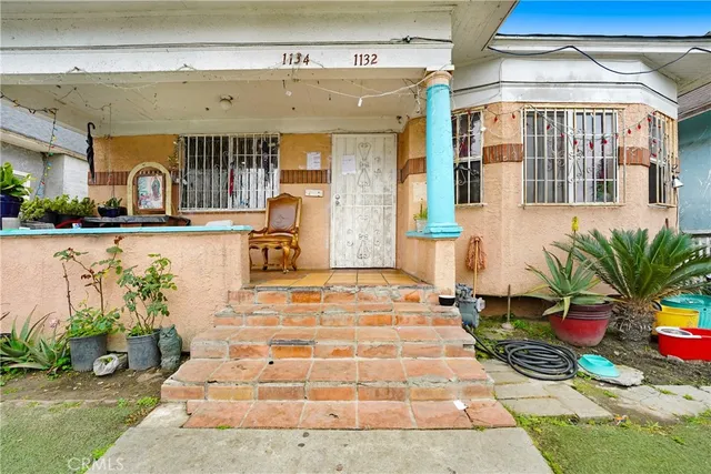 a building with potted plants in front of it