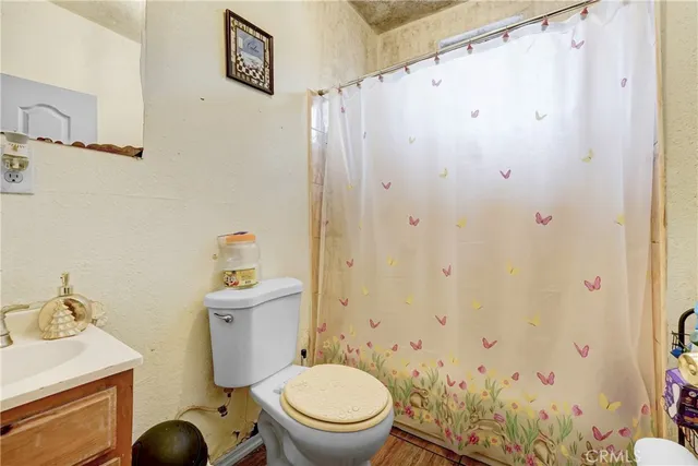 a white toilet sitting next to a bathroom sink