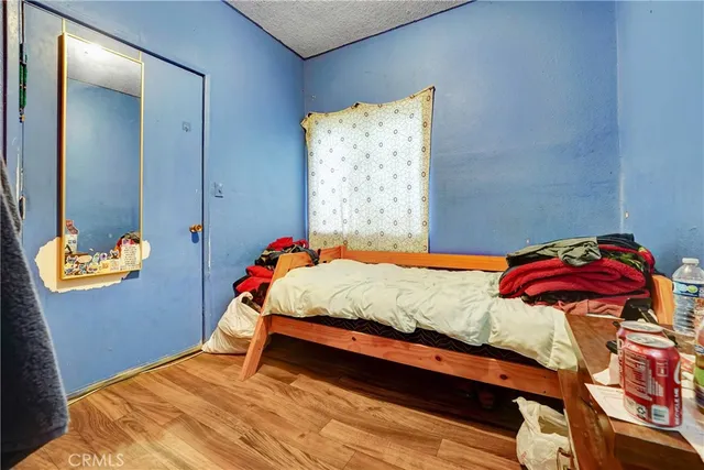 a bedroom with a bed and a painting on the wall