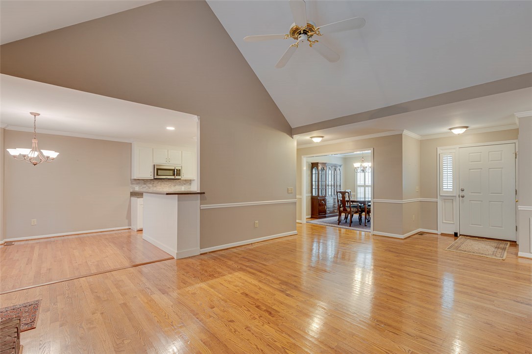 302 Wild Rice Drive Simpsonville, SC 29681 - Photo 7 of 44 Polished wood floors stretch across this airy open layout defined by soaring vaulted ceilings.