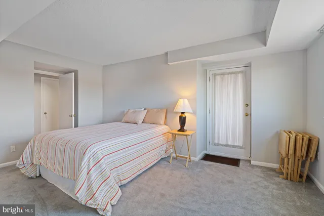 a bedroom with a bed and dresser