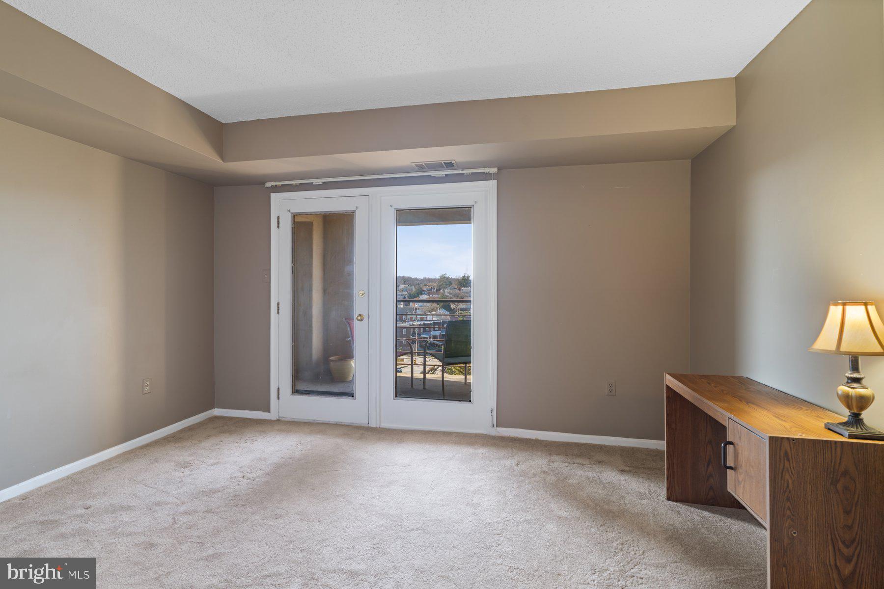 1040 Deer Ridge Drive, Unit 402 Baltimore, MD 21210 - Photo 19 of 34 2nd Bedroom (middle) with balcony access