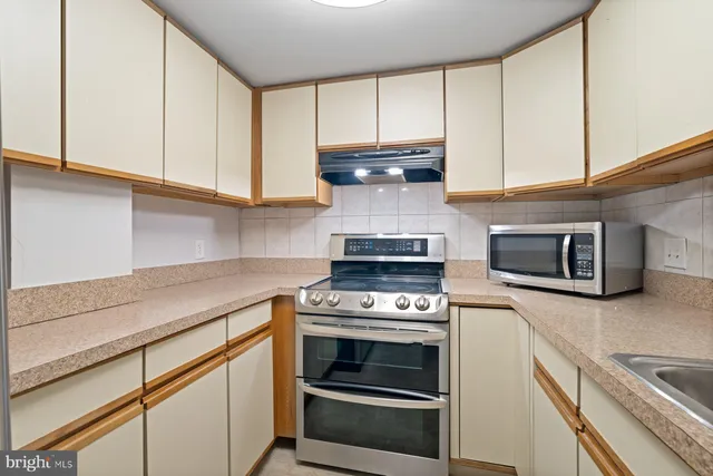 a kitchen with a refrigerator and a sink