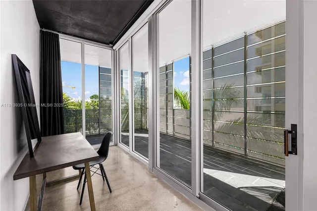 a dining room with furniture and a potted plant