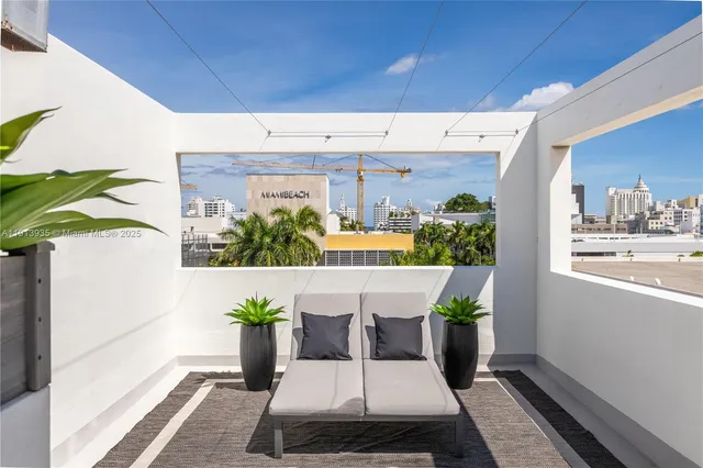 a view of a patio with table and chairs and potted plants